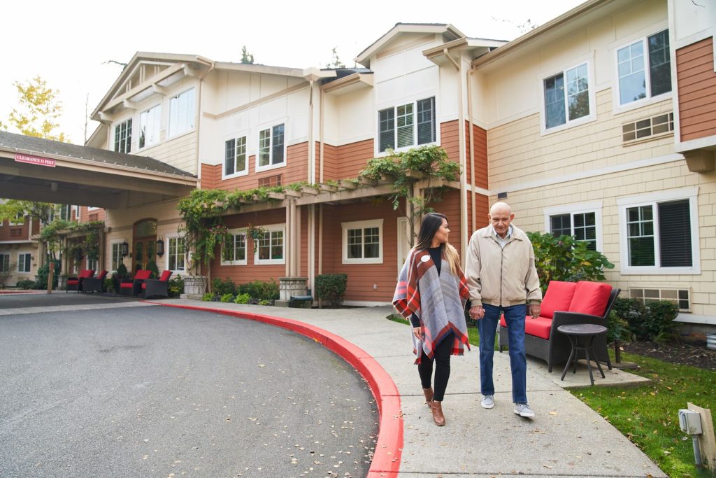 A resident walking outside with an employee