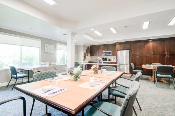 An informal eating area with a kitchen in the background