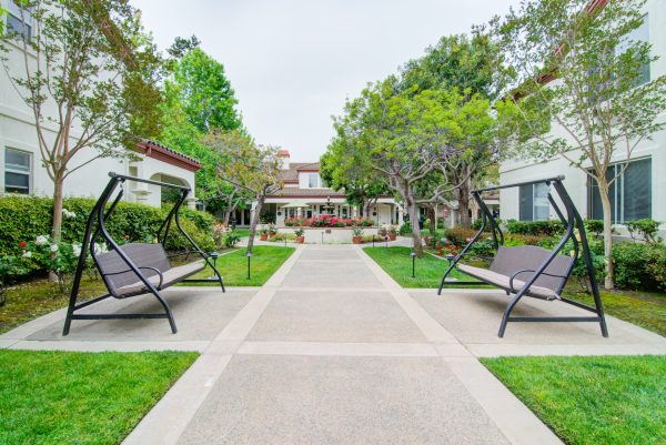 An outdoor path with porch swings on either side