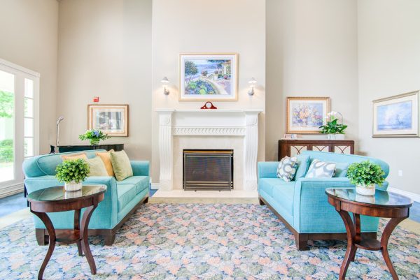 The lobby, with two blue couches and a white fireplace