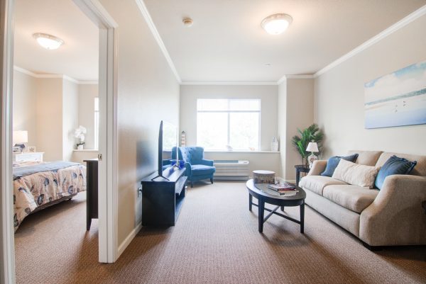 A small living room leading into a bedroom