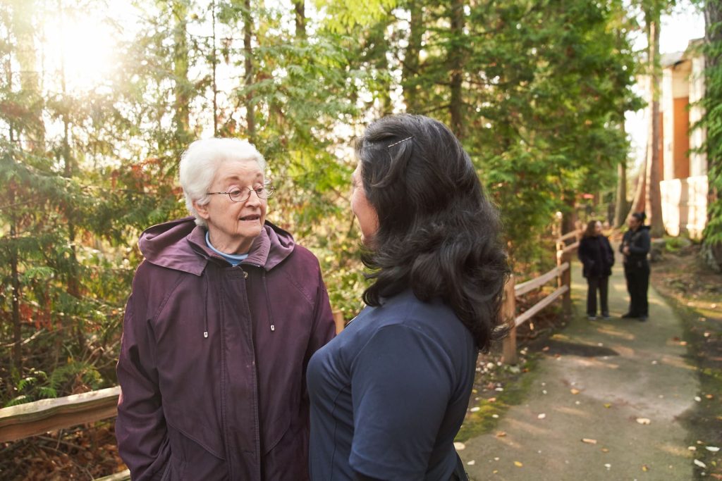 A resident talking to an employee outside