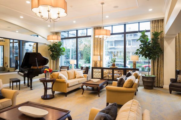 The lobby with couches, coffee tables, and a grand piano