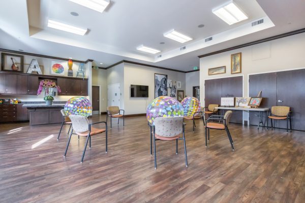 A workout room with chairs and exercise balls