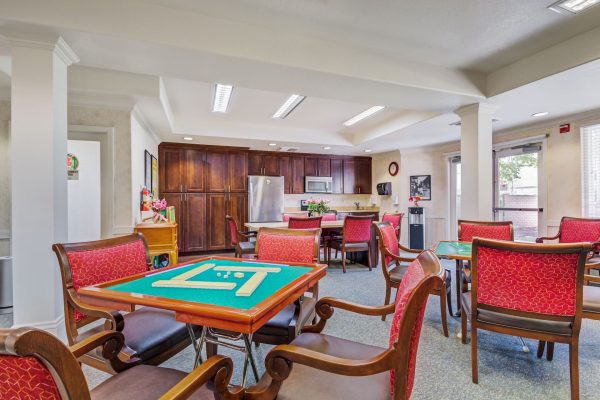 A small game room with a kitchenette at the back.