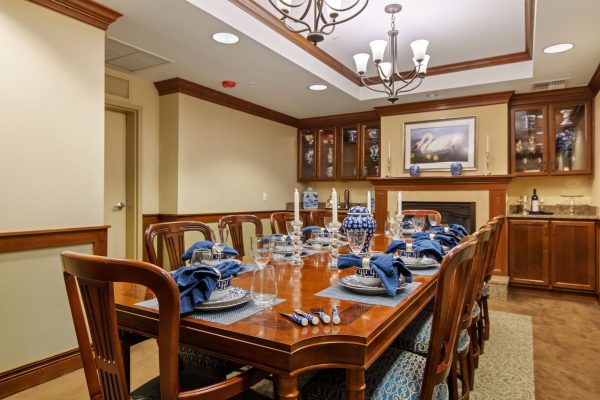 A dining table set with blue and white plates and bowls.