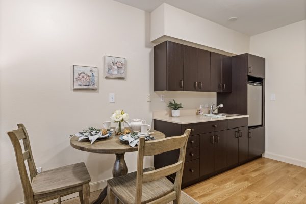 A small kitchenette with a table and two chairs