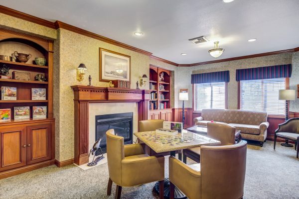 A seating area with a table and chairs, couch, and fireplace