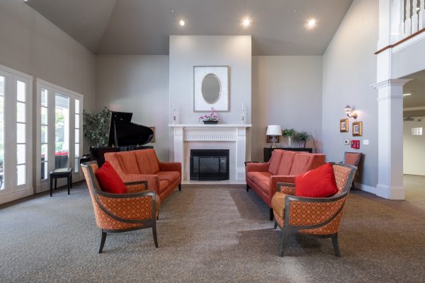 A large seating area with two couches, two chairs, and a fireplace