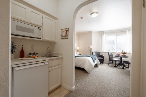 A small kitchenette leading into a bedroom