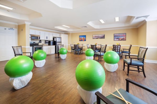 A large room with green workout balls placed in a circle