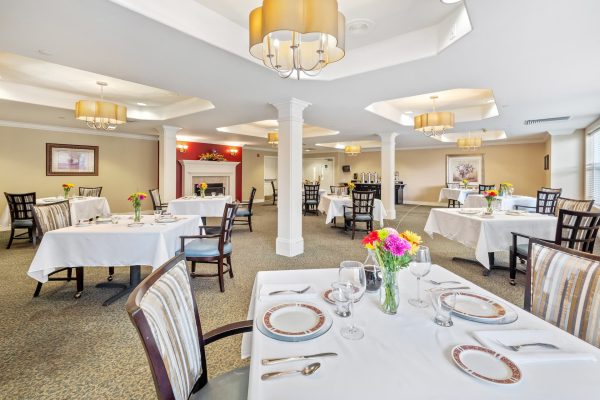 A formal dining area with tables and chairs