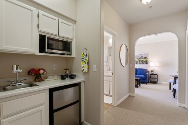 A small kitchenette leading into the living room