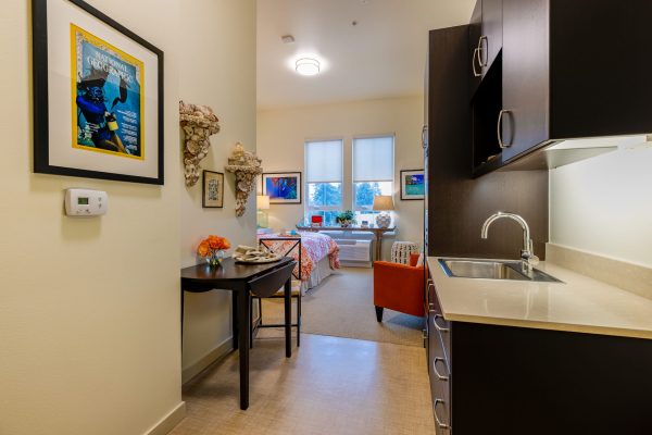 A small kitchenette leading into a bedroom