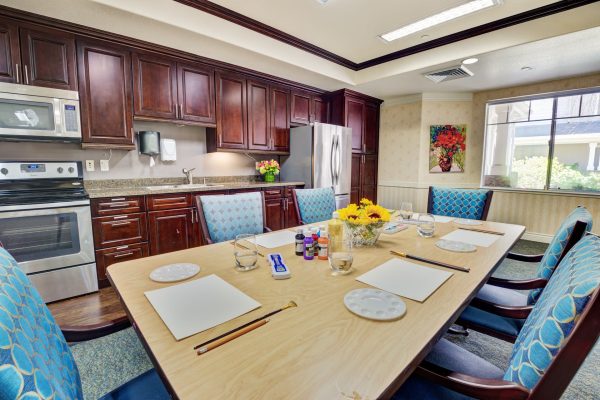 A kitchen with a large dining table and chairs