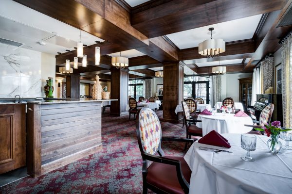 A formal dining area with tables and chairs