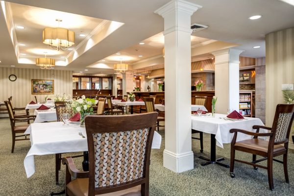 A formal dining area with tables and chairs