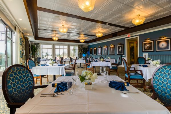 A large, elegant dining room with tables and chairs