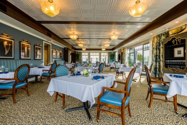 A large, elegant dining room with tables and chairs