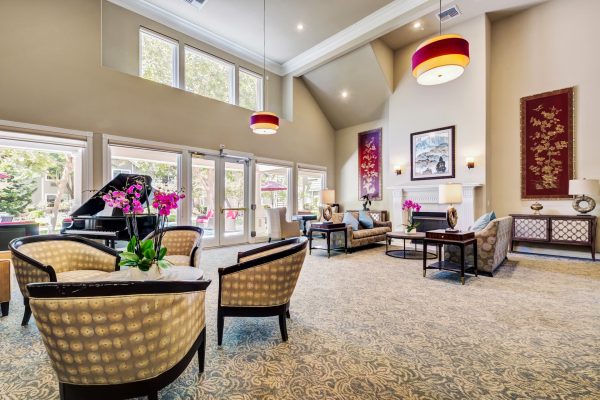 The large lobby at Aegis Gardens, which has chairs and tables.