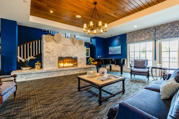 A closer view of the lobby fireplace, with a couch and chairs facing it