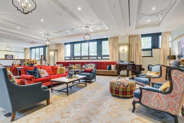 A large seating area with several couches, armchairs, and coffee tables