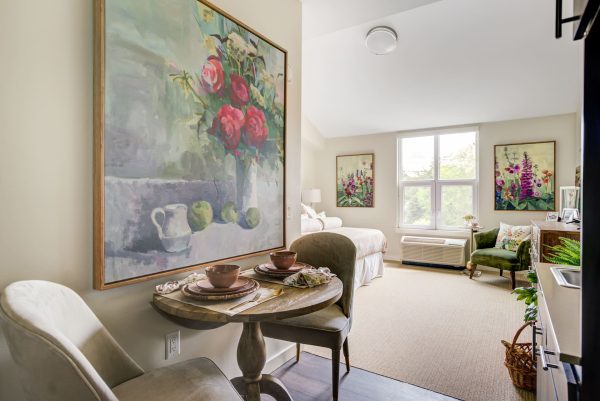 A bright bedroom with a small table and chairs