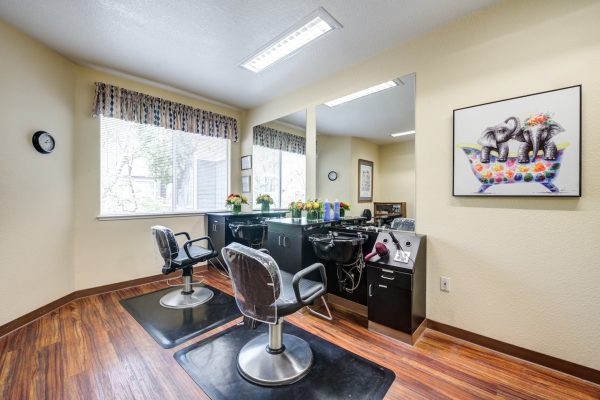 A small salon with two chairs and two washing stations