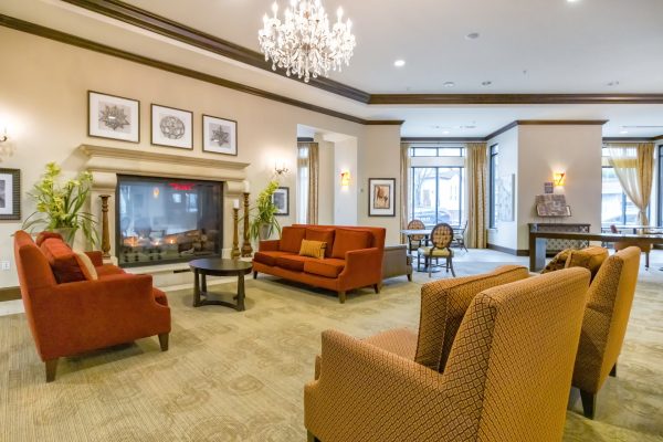 Armchairs, couches, a coffee table, and a fireplace in the lobby