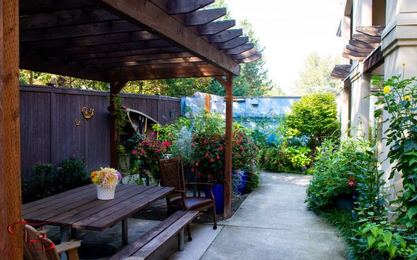 A garden area with a picnic table and chairs