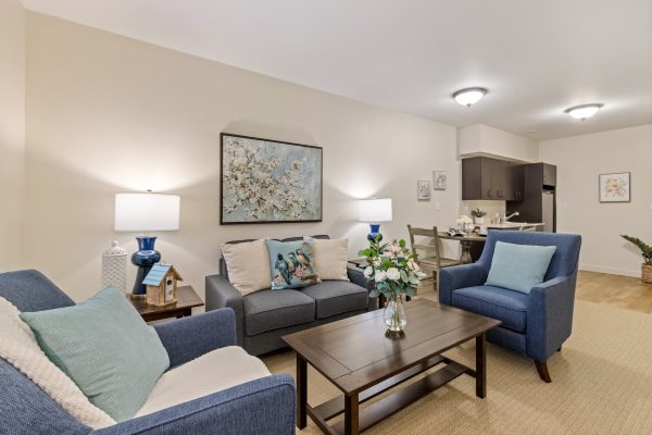 A living room with a couch, chairs, and a coffee table