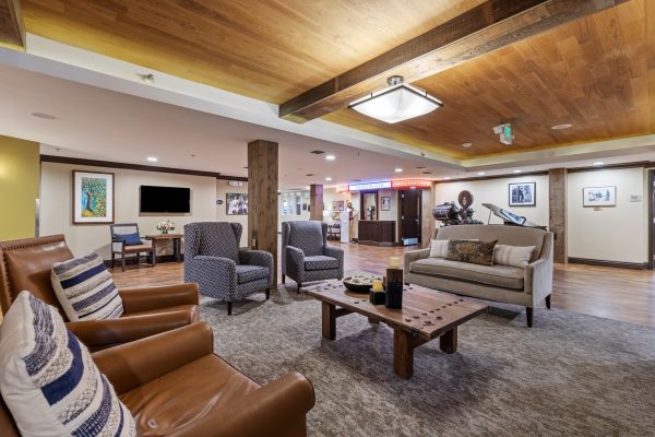 A large seating area with a couch, coffee table, and armchairs