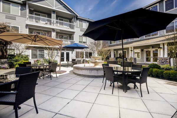 An outdoor dining area with tables, chairs, and umbrellas