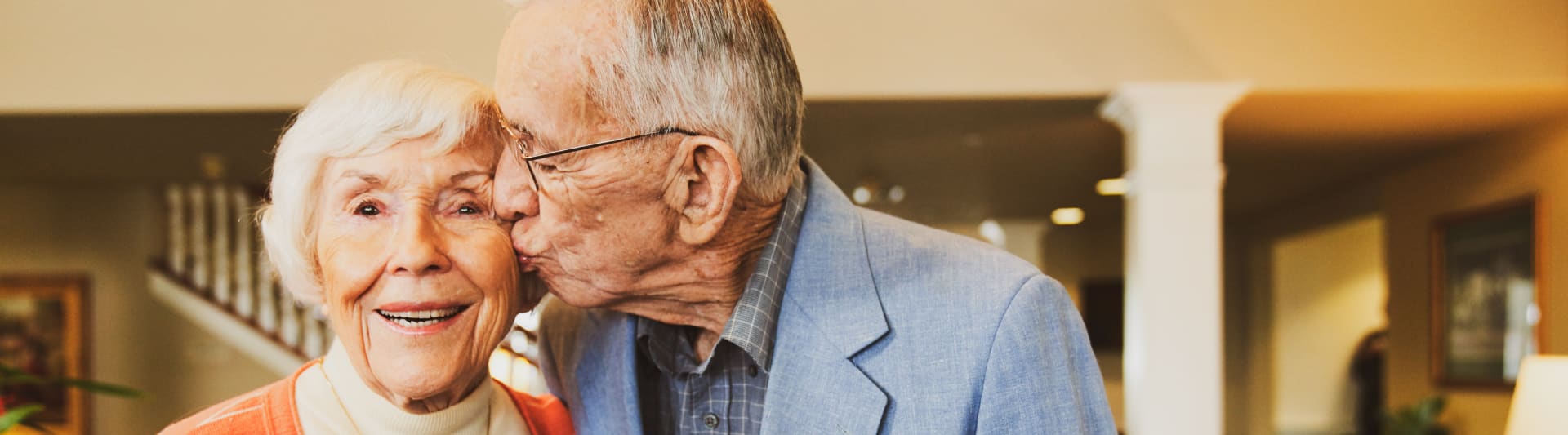 A resident kissing another resident on the cheek