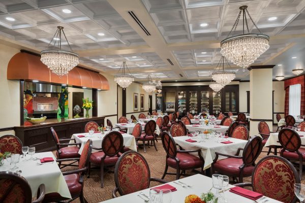 A large dining area with tables, chairs, and chandeliers