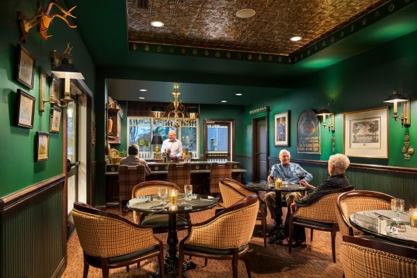 A bar area with tables and chairs