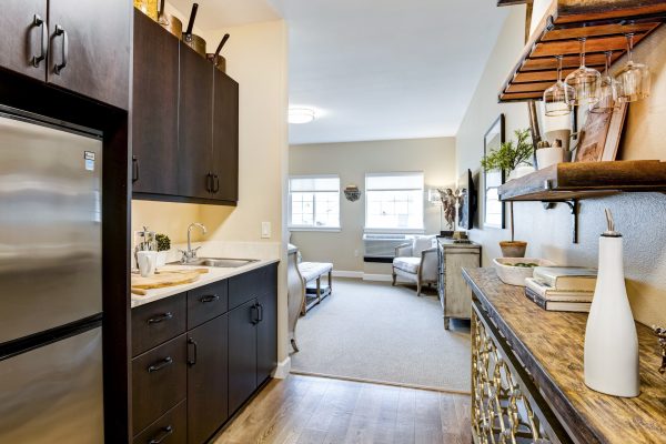 A small kitchenette leading into a bedroom