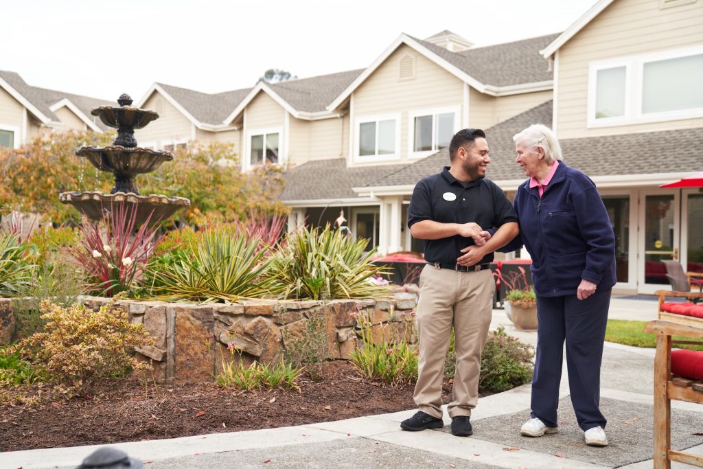 A resident walking outside with an employee