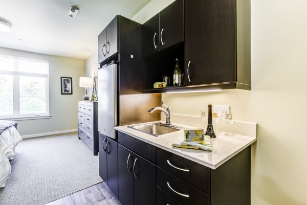 A small kitchenette leading into a bedroom