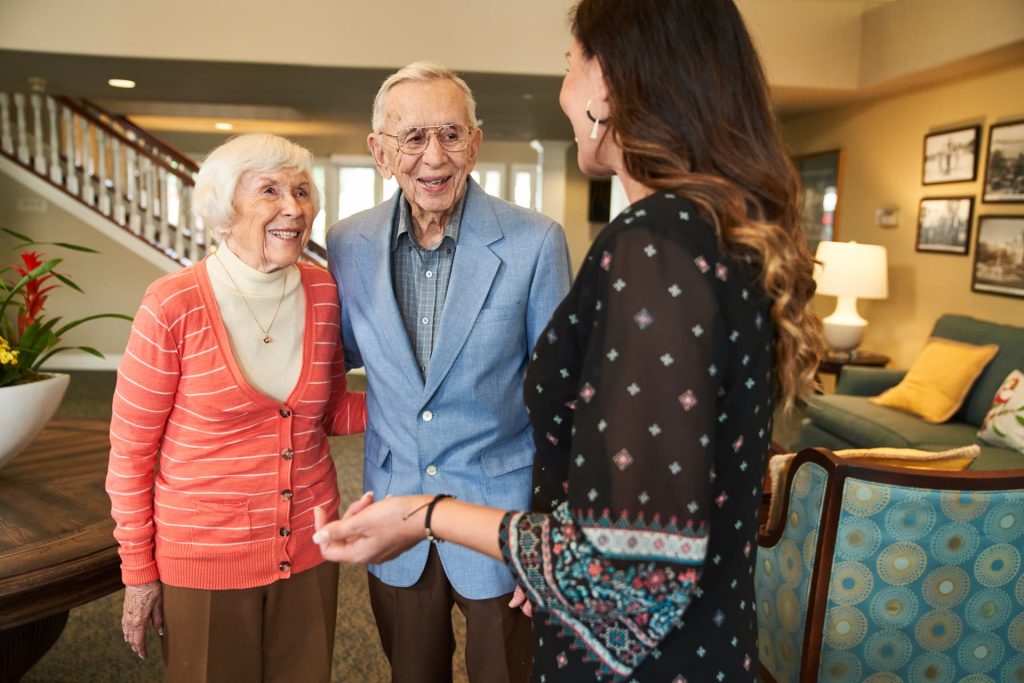 Two residents talking to an employee