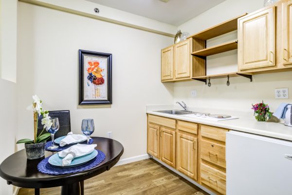 A kitchenette with a table and a chair