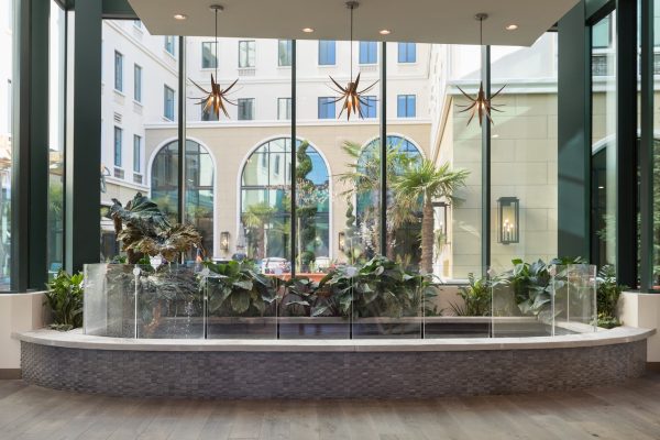 An indoor pond in front of a large window.