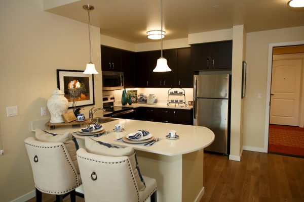 A small kitchen with countertop bar seating