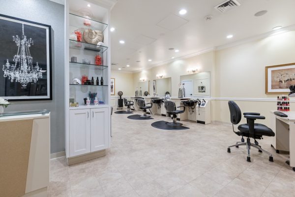 The inside of the salon, with hairdressing stations and a manicure station