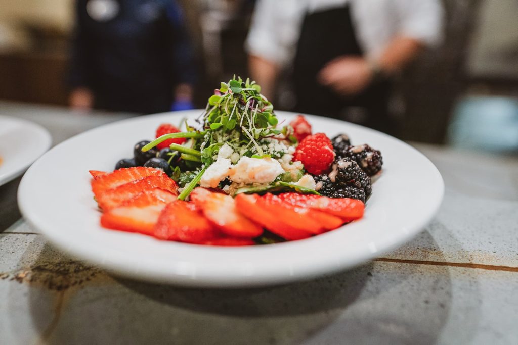 A plate of strawberries, blackberries, and raspberries