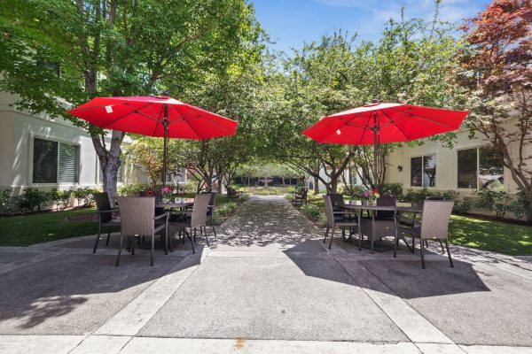 An outdoor seating area with a set of patio tables and chairs