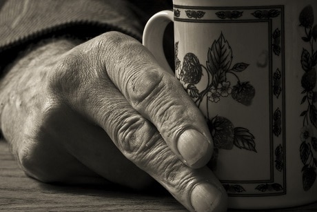 man holding cup of coffee