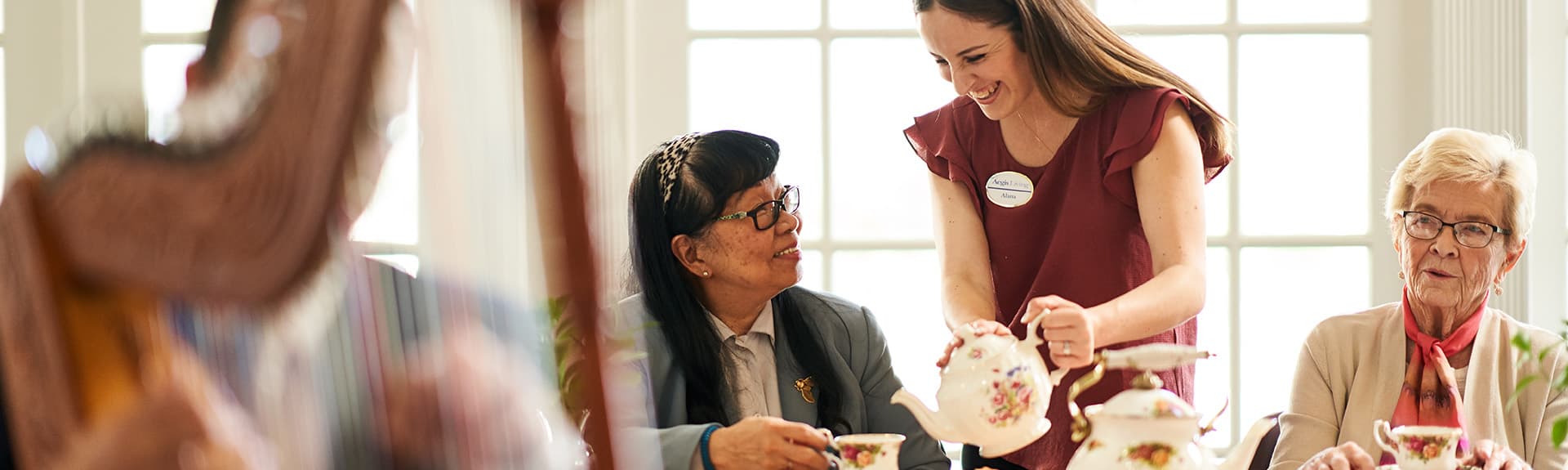 Aegis caregiver, service tea to an Aegis resident