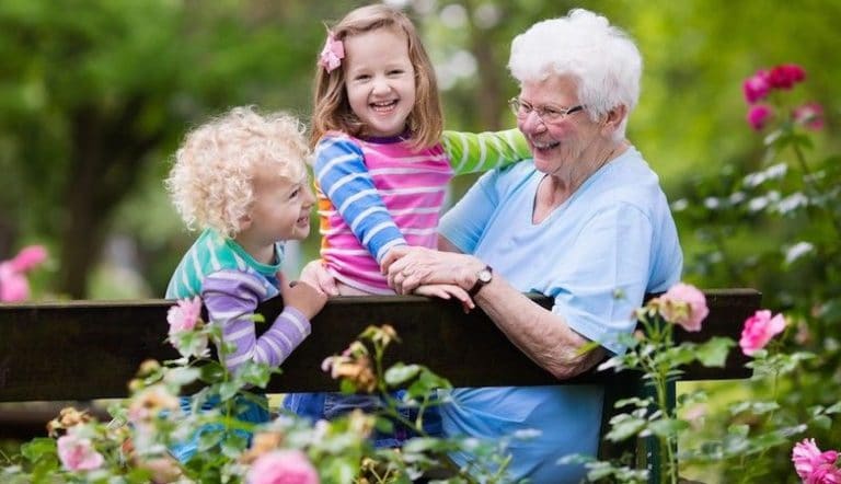 Elderly woman hugging young children