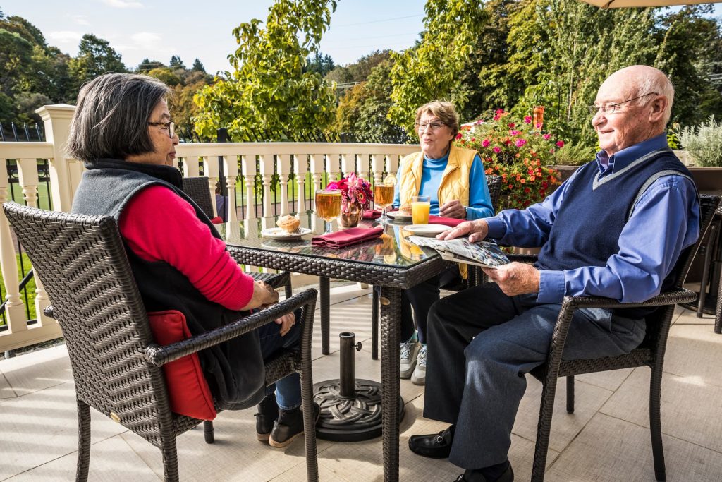 Three residents enjoying a meal outside